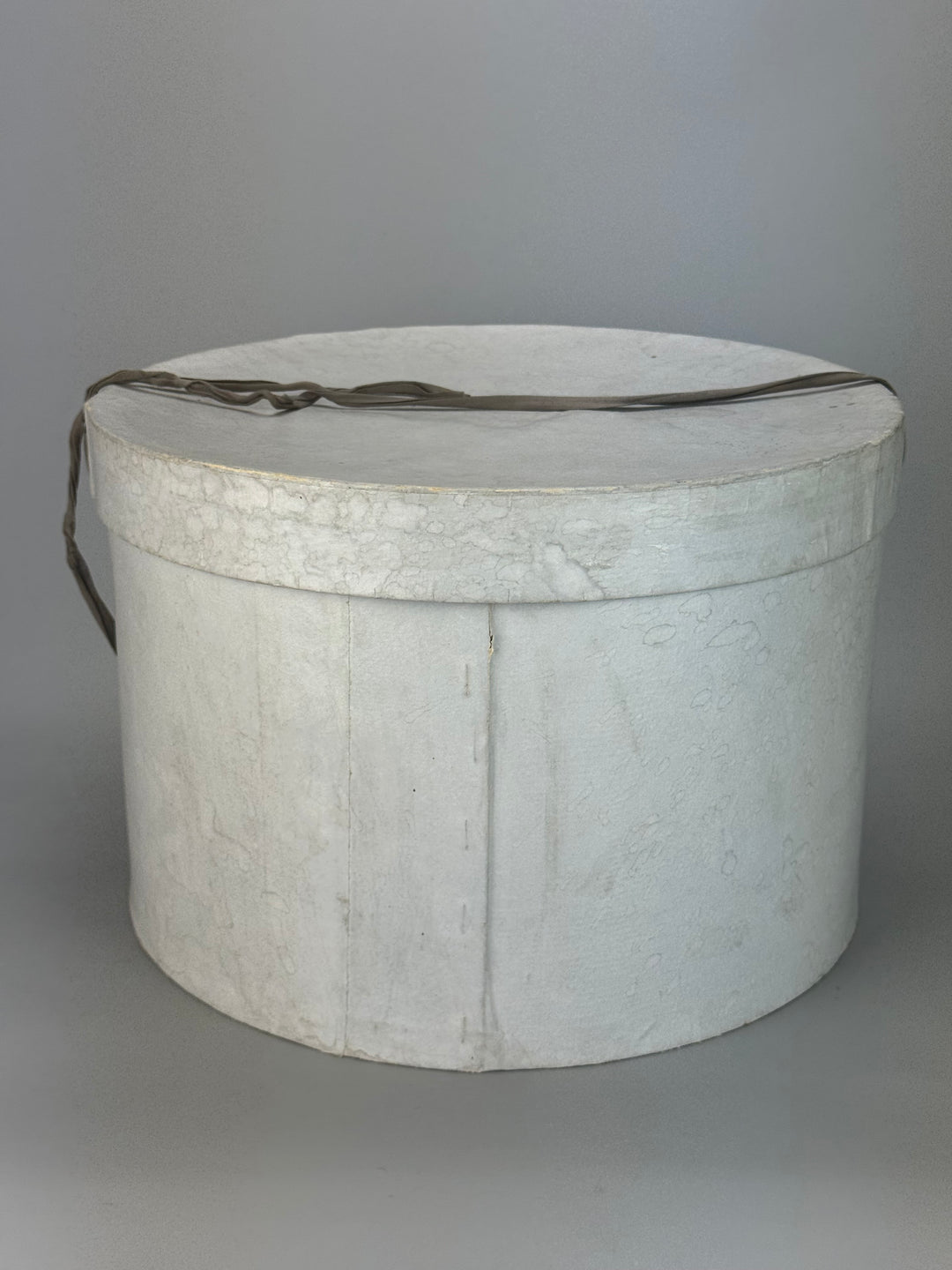 Cappelliera Vintage rotonda in cartone di colore grigio con chiusura a nastro