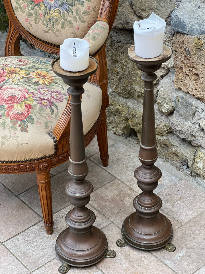 Coppia di candelabri da terra in rame con base tripode e piedi a zampa