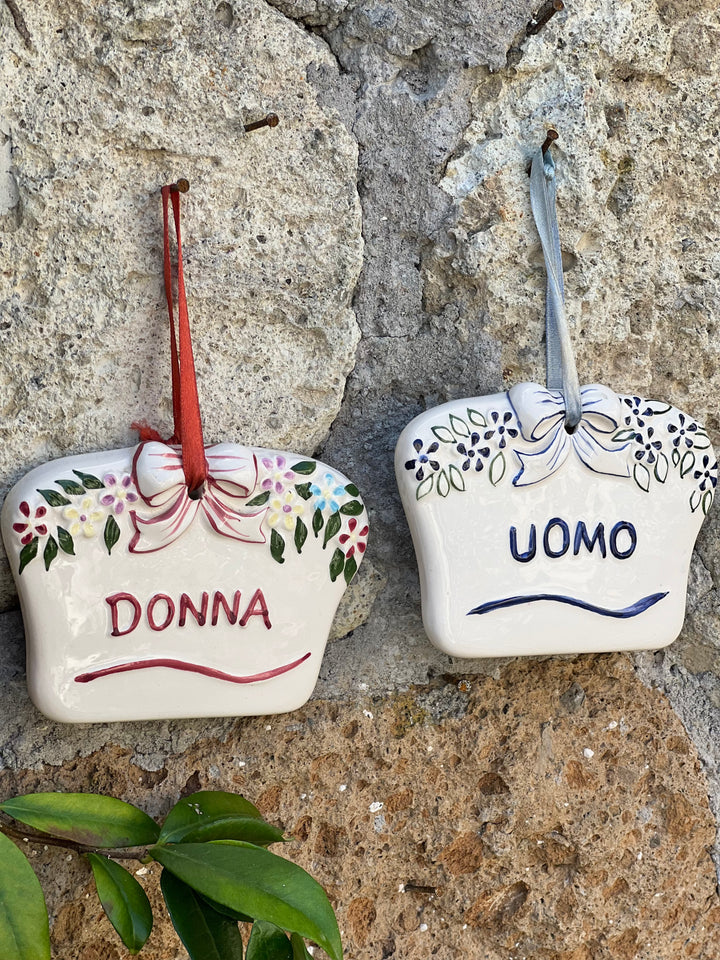 Coppia di targhette vintage in porcellana con scritte Donna e Uomo, fiocchi in rilievo e motivi floreali