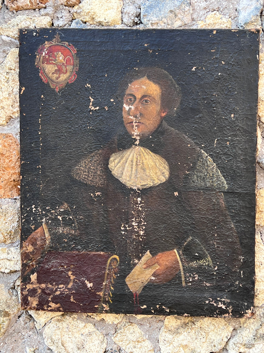 Dipinto olio su tela raffigurante un ritratto maschile di notevole espressività, datato al XVIII secolo. Caratterizzato da una realizzazione intensa e dettagliata, il soggetto è vestito con abiti dell'epoca e appare di fronte a uno sfondo scuro che mette in risalto la sua figura. Situato nella parte superiore sinistra, un intricato stemma araldico aggiunge un tocco di nobiltà e mistero, suggerendo una possibile appartenenza del soggetto a una famiglia di rango.

Misure 70x85 cm