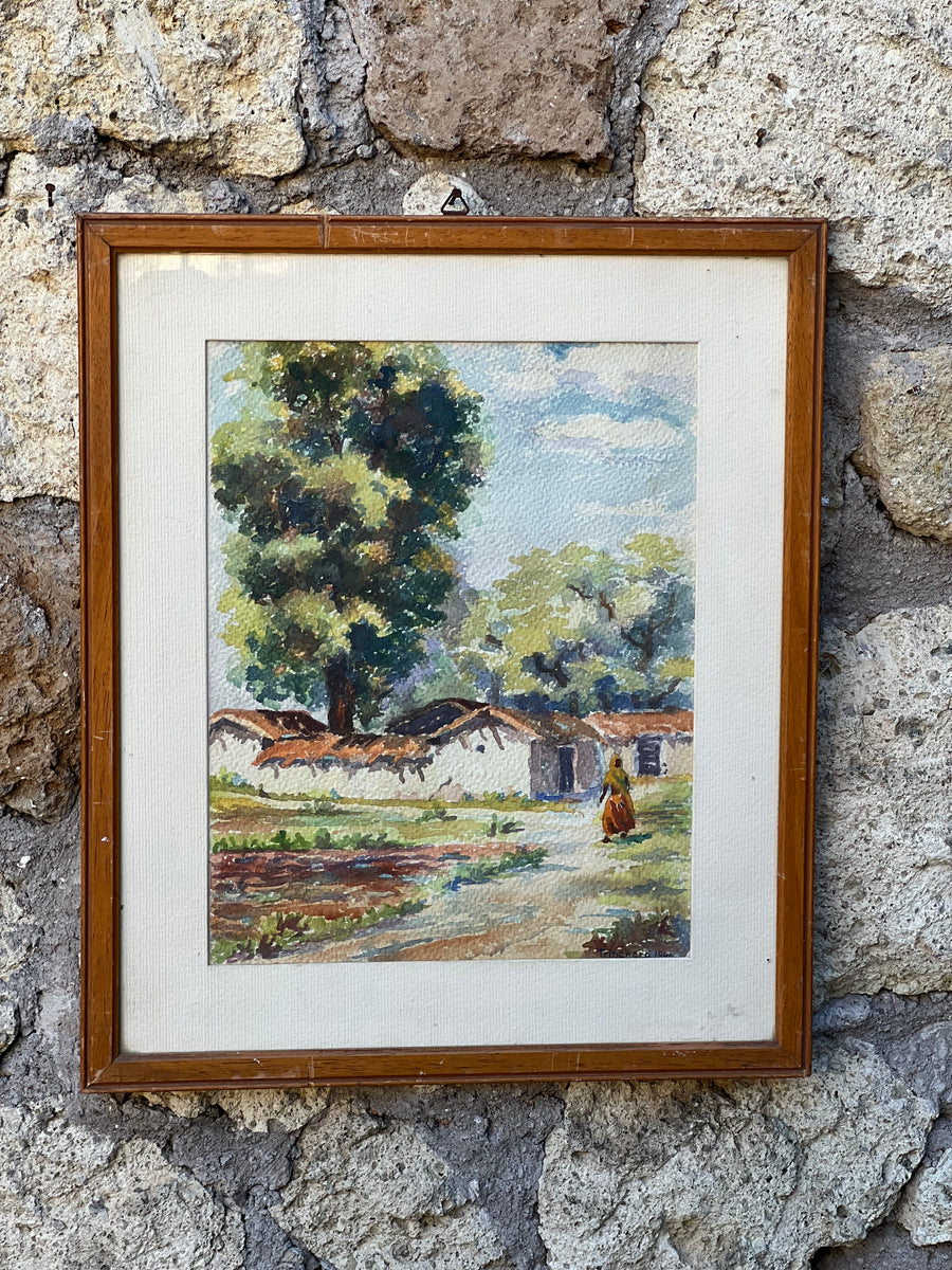 Quadro acquarello su carta realizzato nel 1946 dal pittore Trinchero. La scena mostra una figura solitaria che passeggia, con case rustiche in lontananza, tutto sotto un cielo azzurro punteggiato di nuvole. I colori e la tecnica di pennellata libera evocano una sensazione di pace e semplicità della vita campestre. Incorniciato in una semplice cornice di legno che esalta i toni naturali dell'opera, questo quadro è perfetto per portare un tocco di serenità e bellezza artistica in qualsiasi ambiente.

