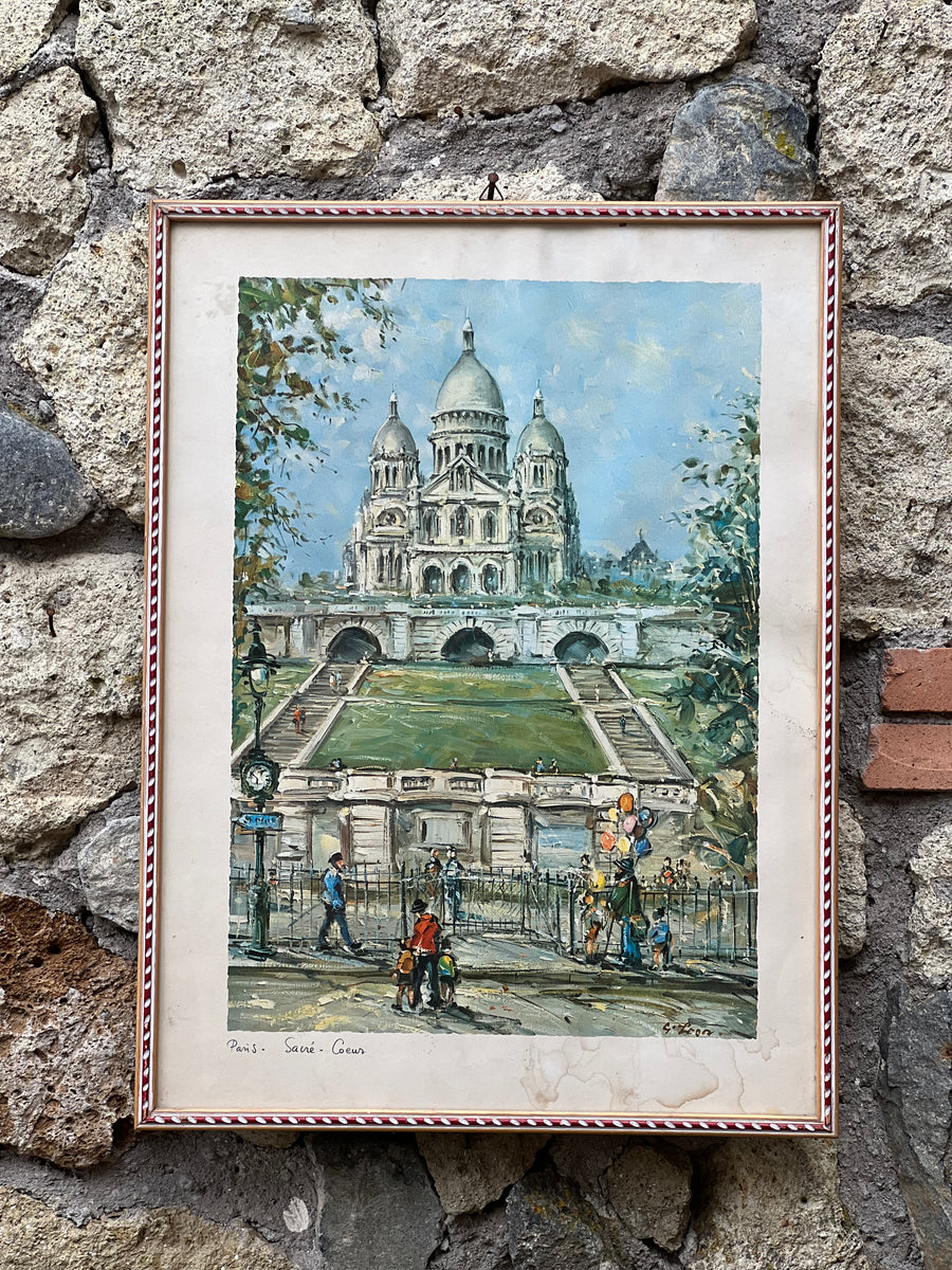 Stampa raffigurante maestosa basilica del Sacré-Cœur di Parigi, uno dei simboli più iconici della città. Quest'opera offre una rappresentazione della basilica vista dai giardini antistanti, con dettagli delle vivaci attività quotidiane che animano il paesaggio urbano circostante.

Misure 42x55 cm