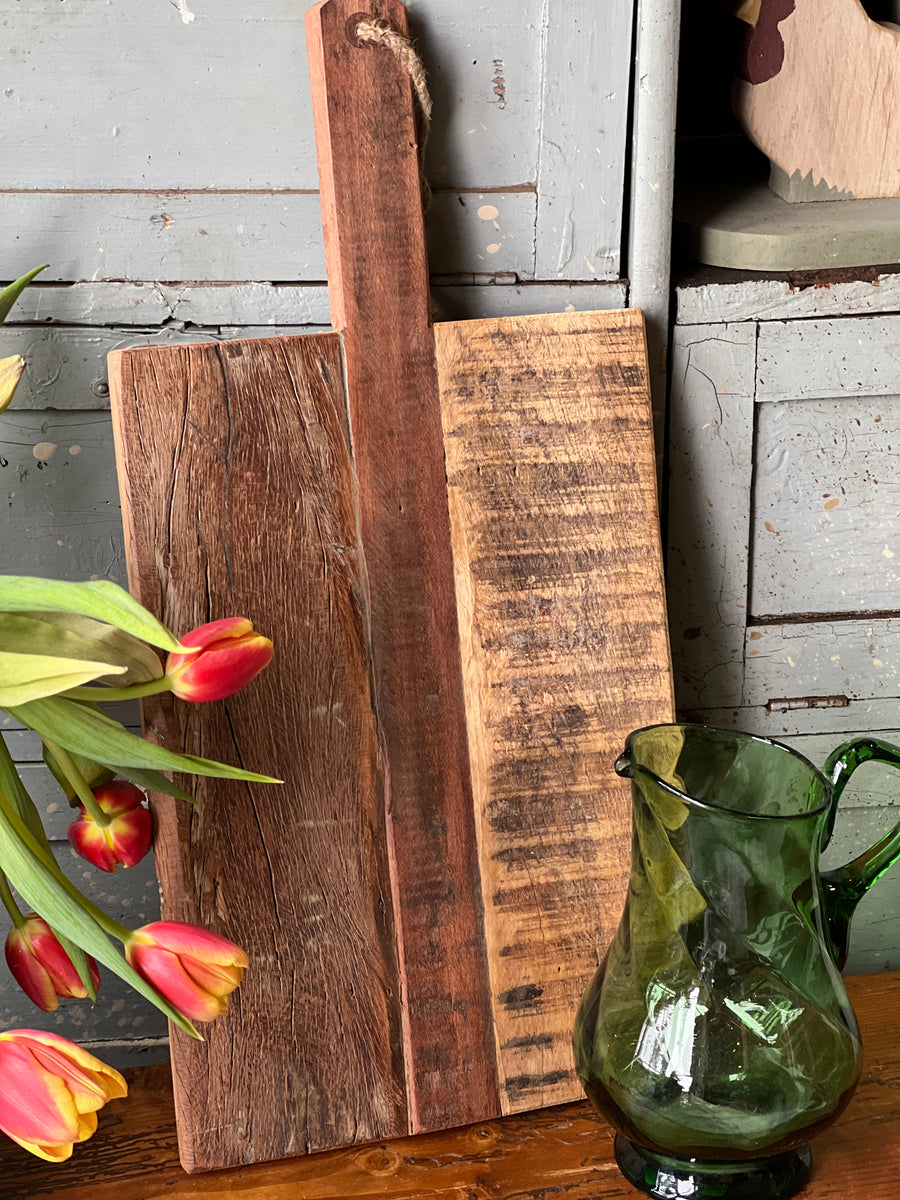 Tagliere realizzato in legno rustico e caratterizzato da un design robusto e una pratica maniglia con corda per appenderlo. Ideale sia per l’uso quotidiano in cucina che come elemento decorativo, questo tagliere è perfetto per servire qualsiasi pietanza, regalando un tocco rustico e fascino naturale all'ambiente.

Misure 25,5x50,5 cm&nbsp;